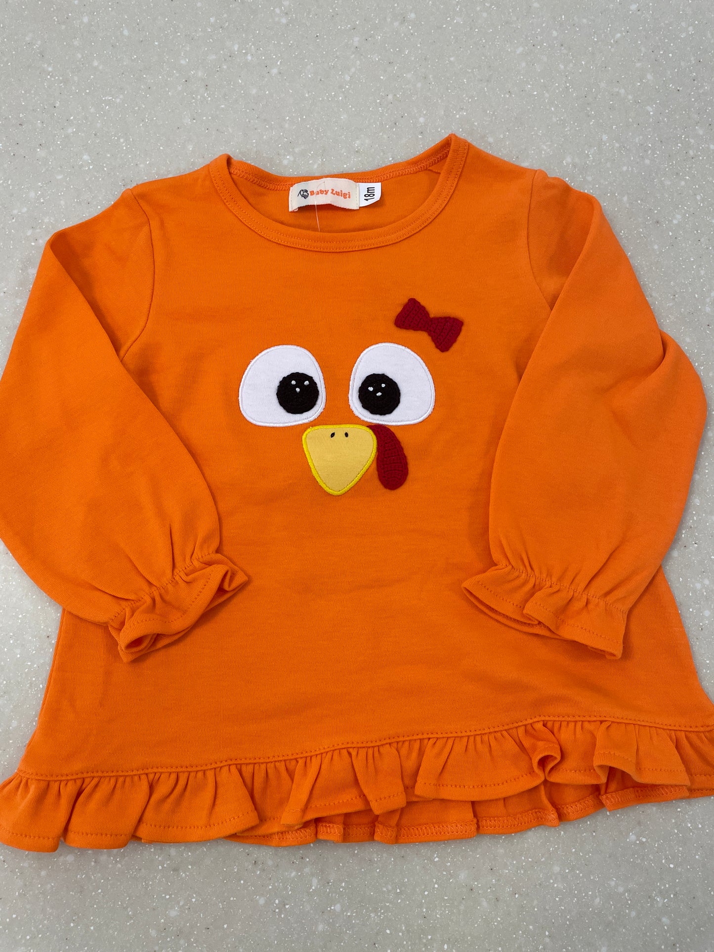 TURKEY EYES RUFFLE TOP